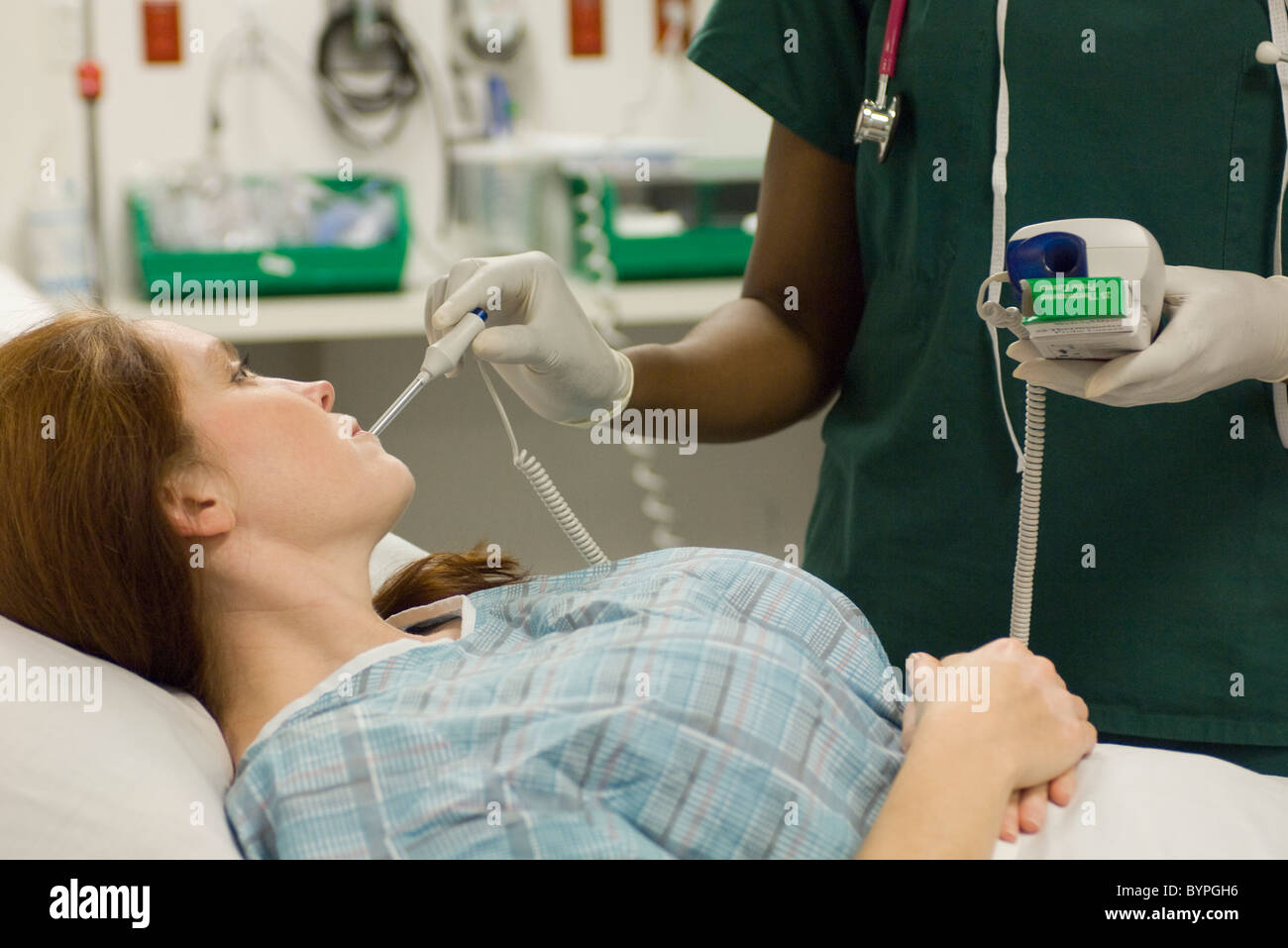Nursing taking patient's temperature Stock Photo