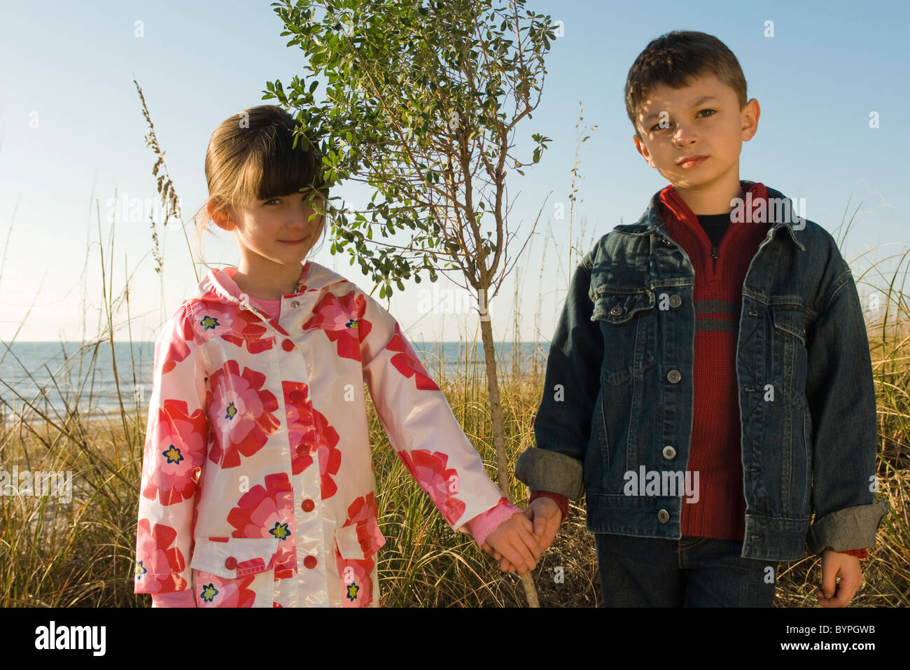 Young boy and girl holding hands, portrait Stock Photo - Alamy
