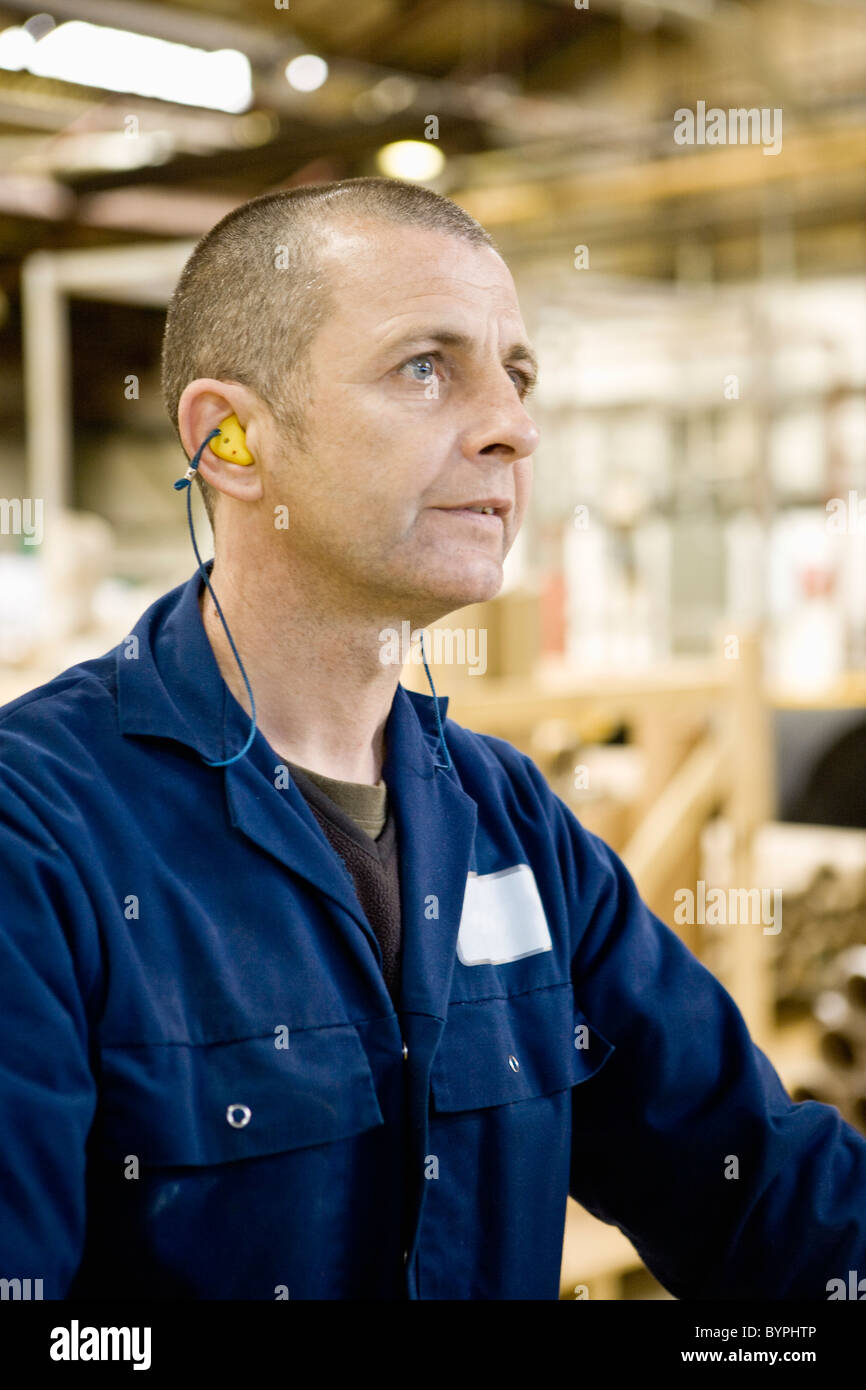 Textile worker concentrating on task in carpet tile factory Stock Photo