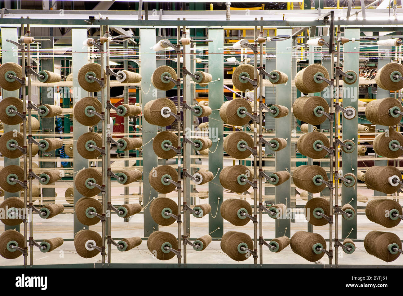 Yarn spools on carpet weaving machine Stock Photo Alamy