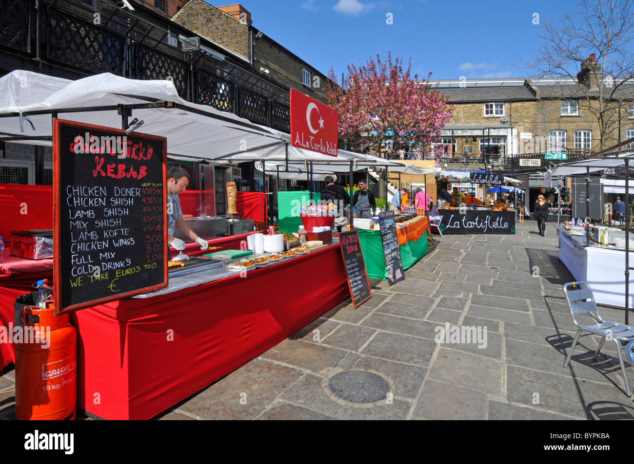 Turkish kebab street food stall business at colourful spring outdoor market Camden London England UK Stock Photo