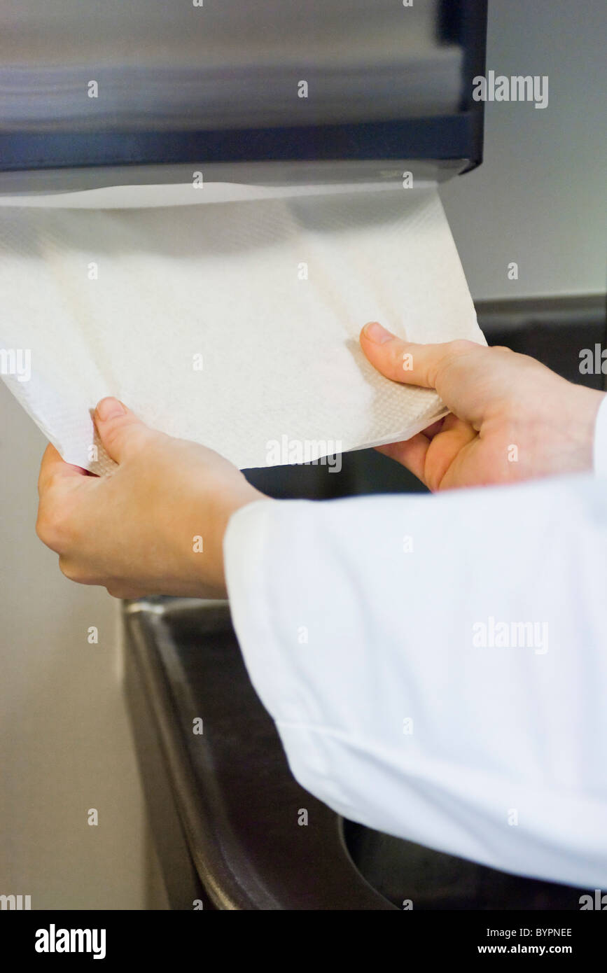Taking paper towel from dispenser Stock Photo