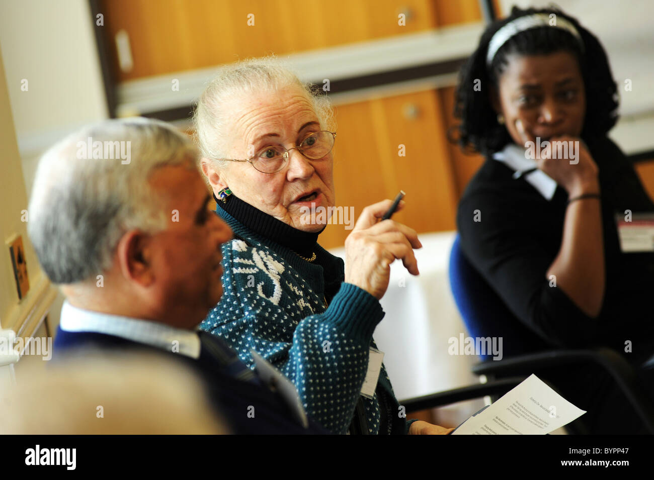 group of mixed race people talking at a public council meeting Stock ...