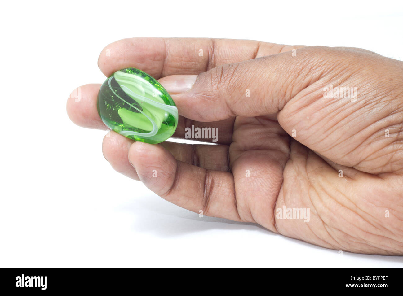 A beautiful green and white marble held by hand for display Stock Photo