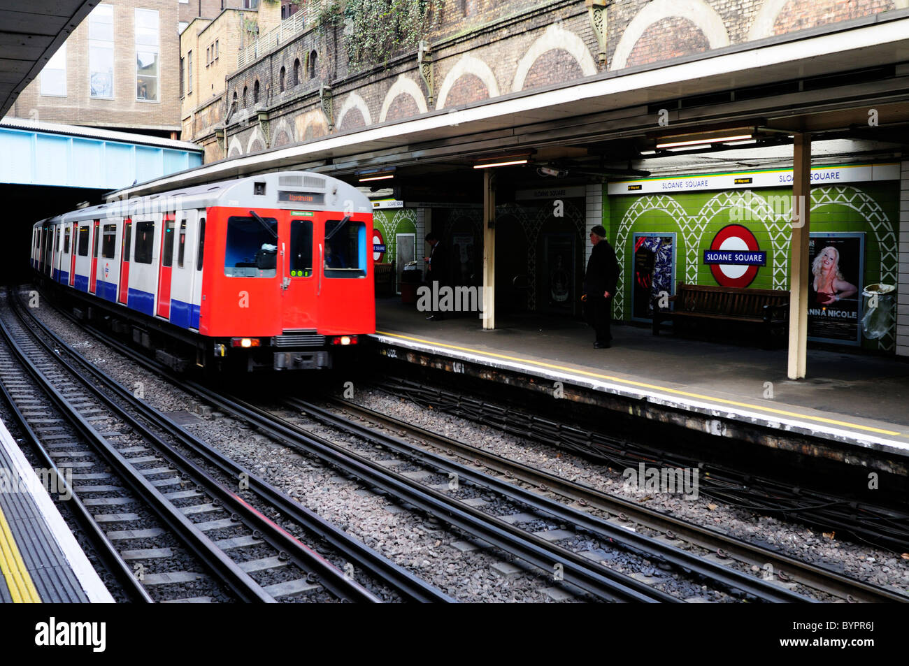 A District Line Train at Sloane Square Underground Tube Station, London, England, UK Stock Photo