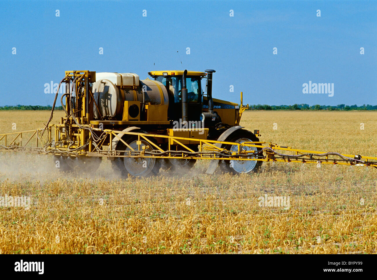 Chemical application; RoGator broadcasts Roundup herbicide over the top of RoundupReady conservation tillage early growth cotton Stock Photo