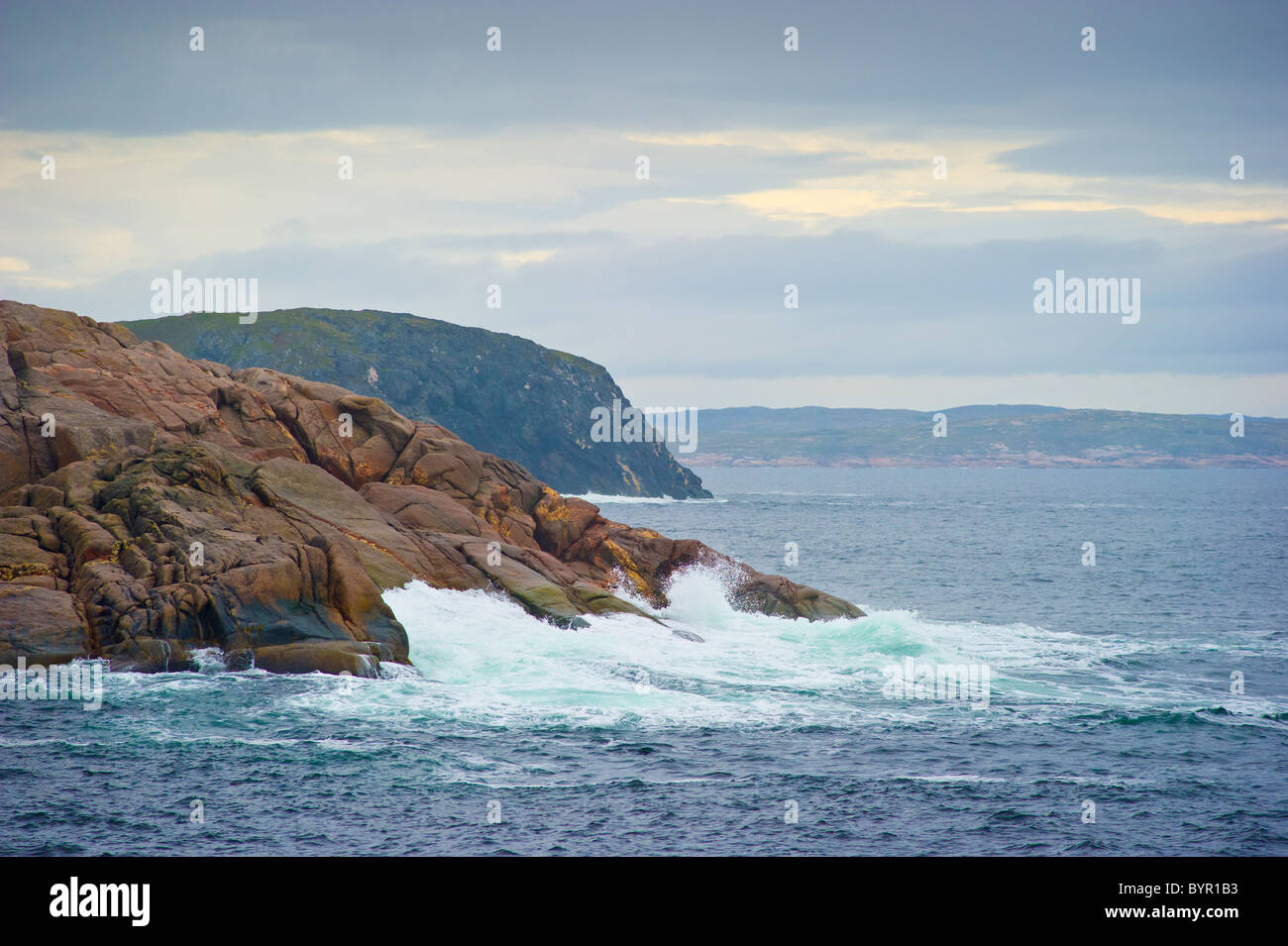 Cliffs with waves breaking near Battle Harbour Newfoundland Labrador Stock Photo