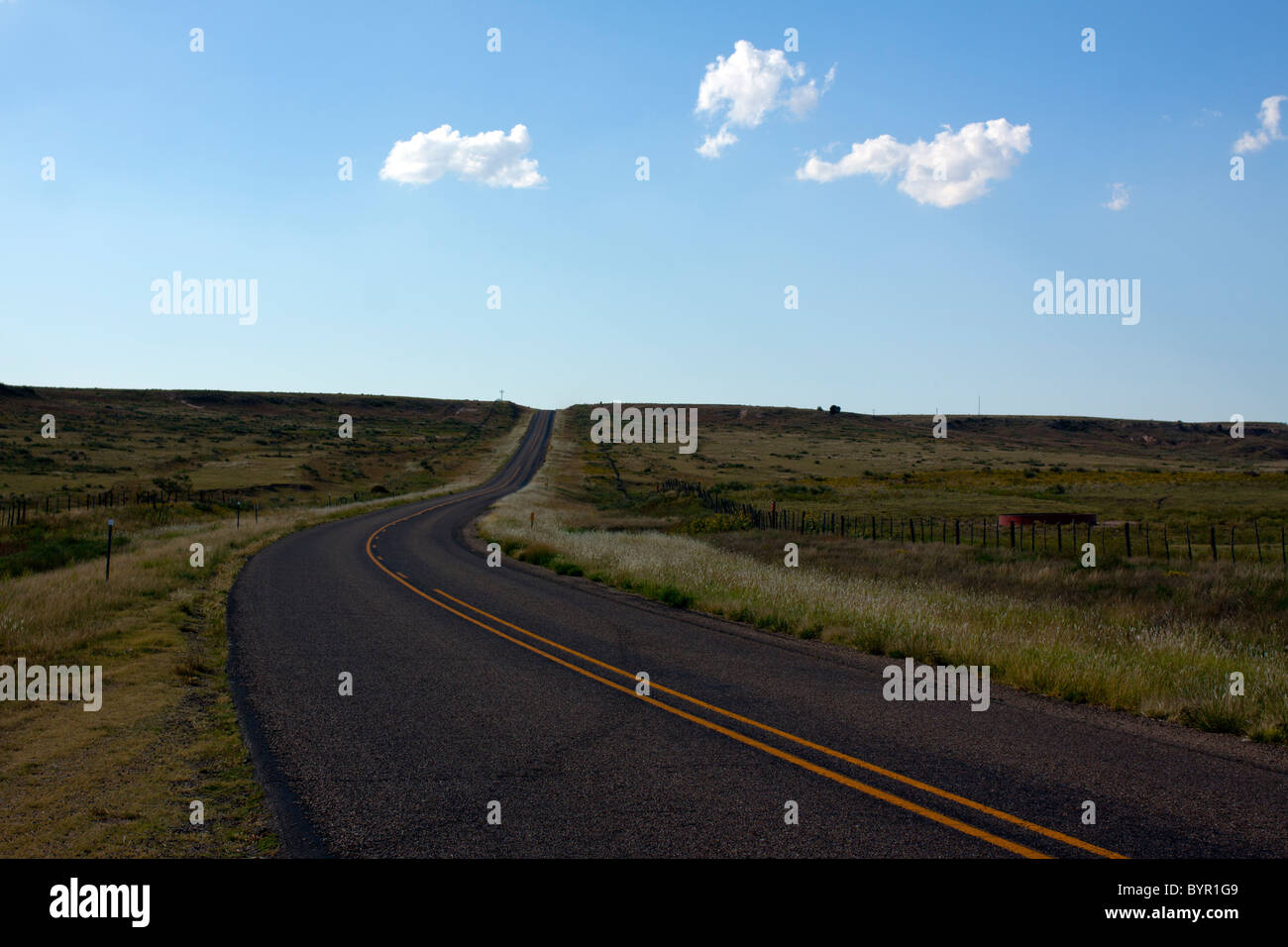 A lonely country highway in the high desert plains of Texas. Stock Photo