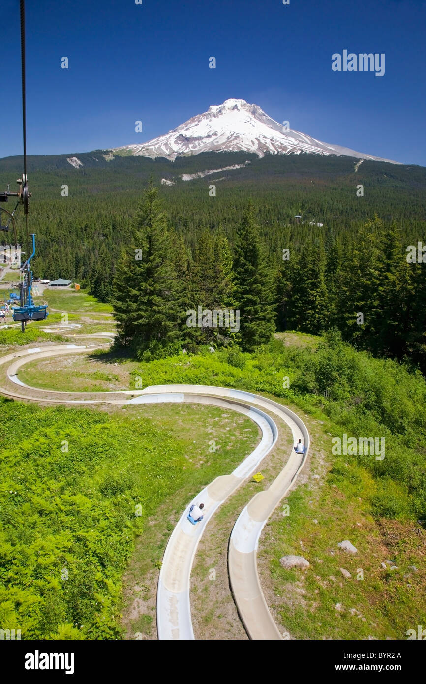 a chair lift and a track with a view of mount hood in the oregon
