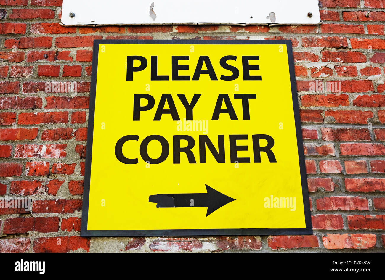 please pay at corner sign Stock Photo