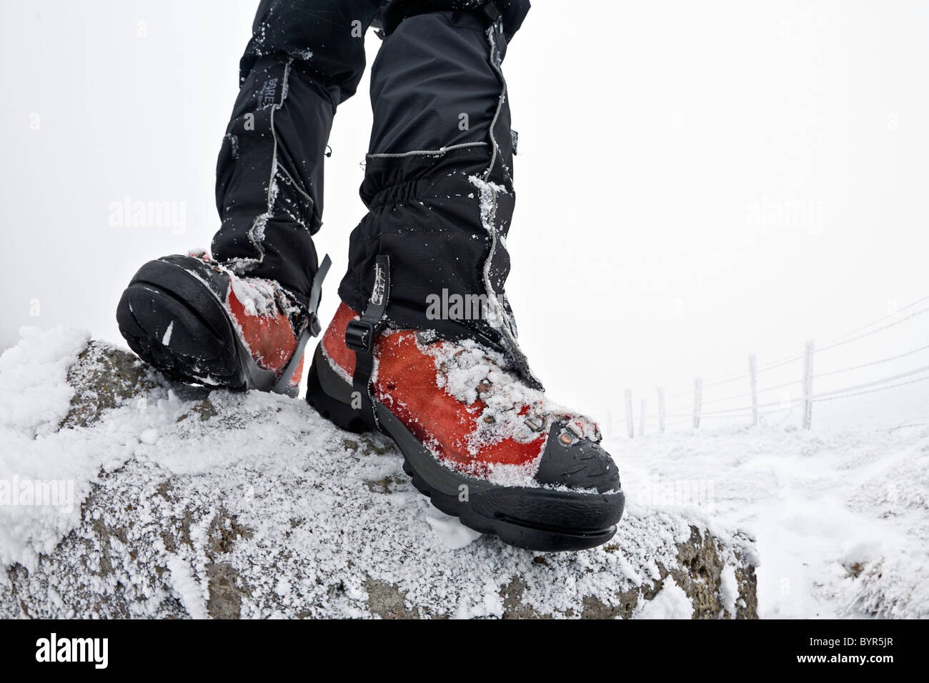A hiker fitted up with waterproof walking boots and gaiters. Randonneur équipé de chaussures de marche et de guêtres. Stock Photo