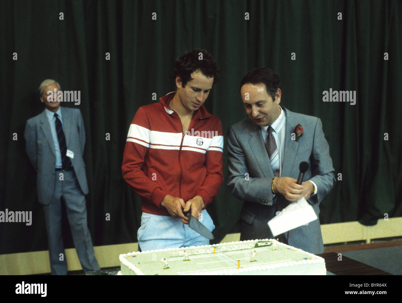 John McEnroe cuts the cake to open the Telford Tennis Centre with Peter Lloyd Stock Photo