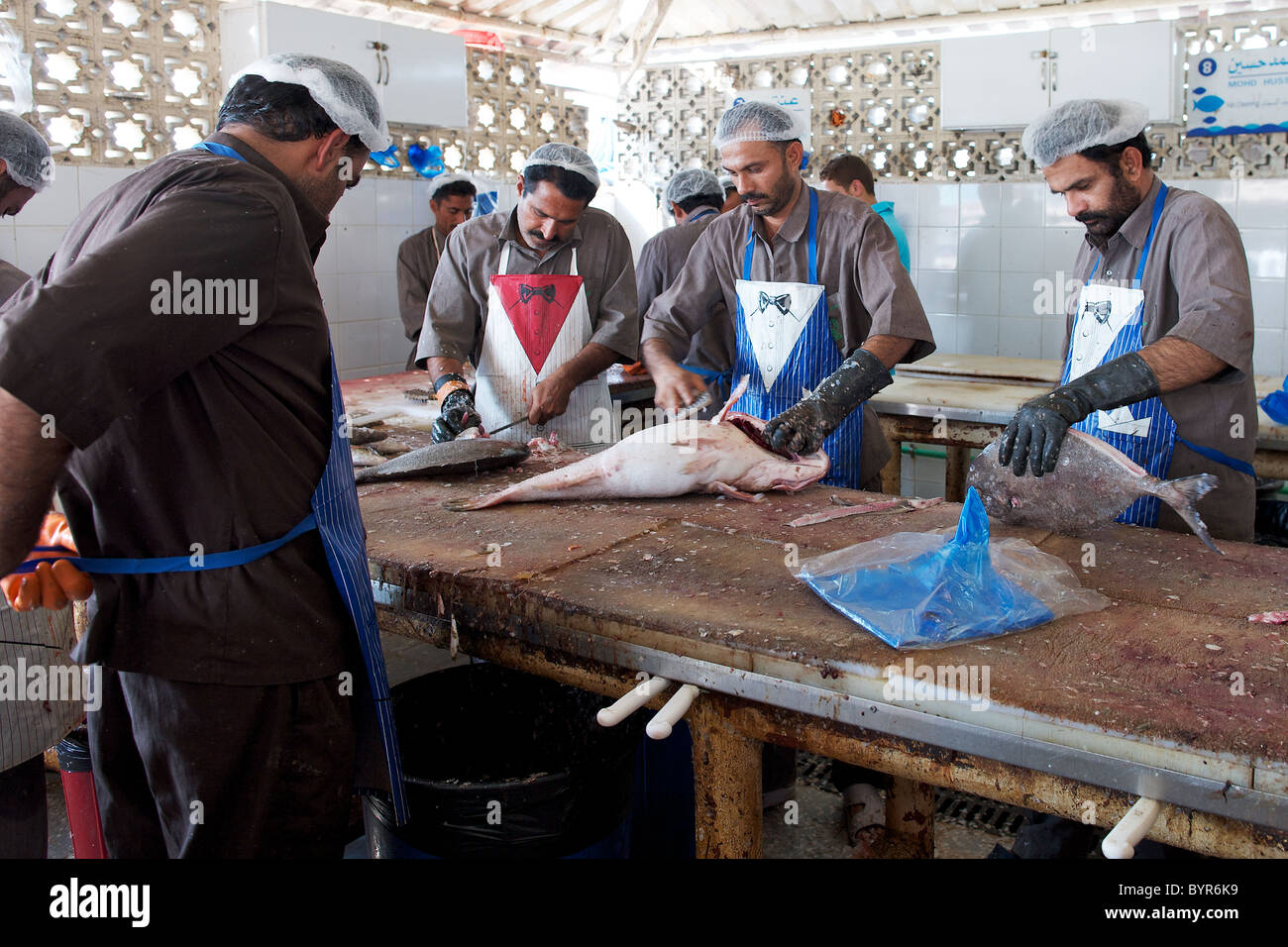 Cleaning fish at Sharjah fish market, Dubai, UAE Stock Photo Alamy