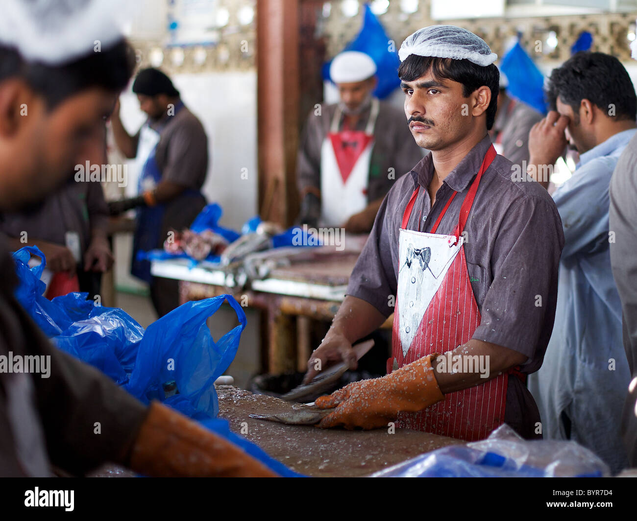 Cleaning fish at Sharjah fish market, Dubai, UAE Stock Photo Alamy