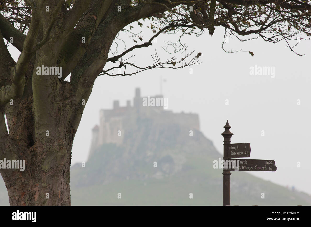 a landmark distance sign and lindisfarne castle; holy island, northumberland, england Stock Photo