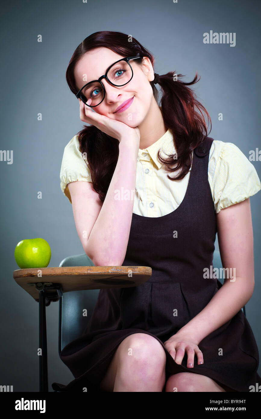 geeky school girl daydreaming at her desk Stock Photo - Alamy