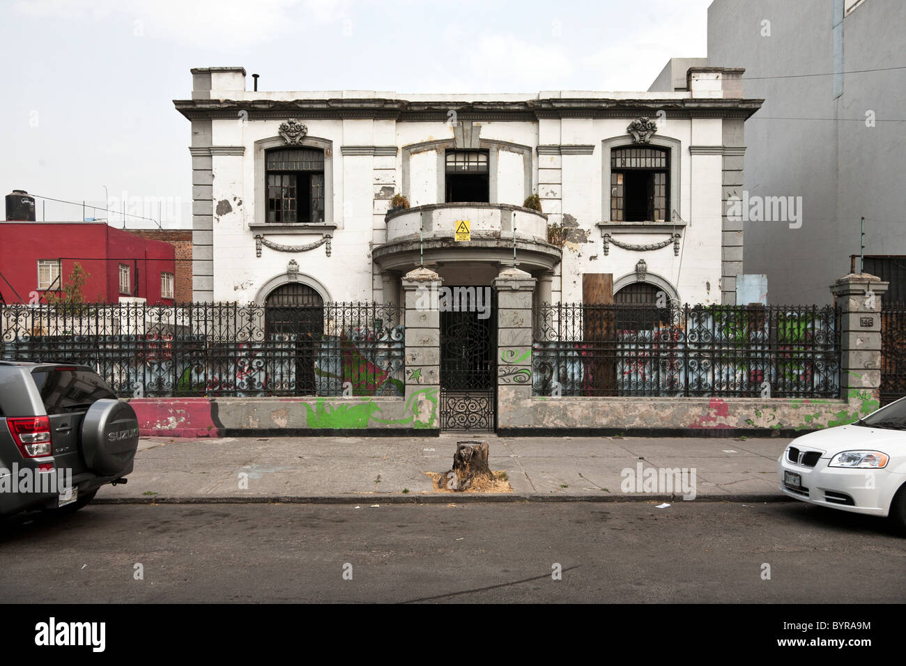 deteriorated once proud Porfirian Belle Epoch mansion with elegant wrought iron fence about to undergo restoration Mexico City Stock Photo