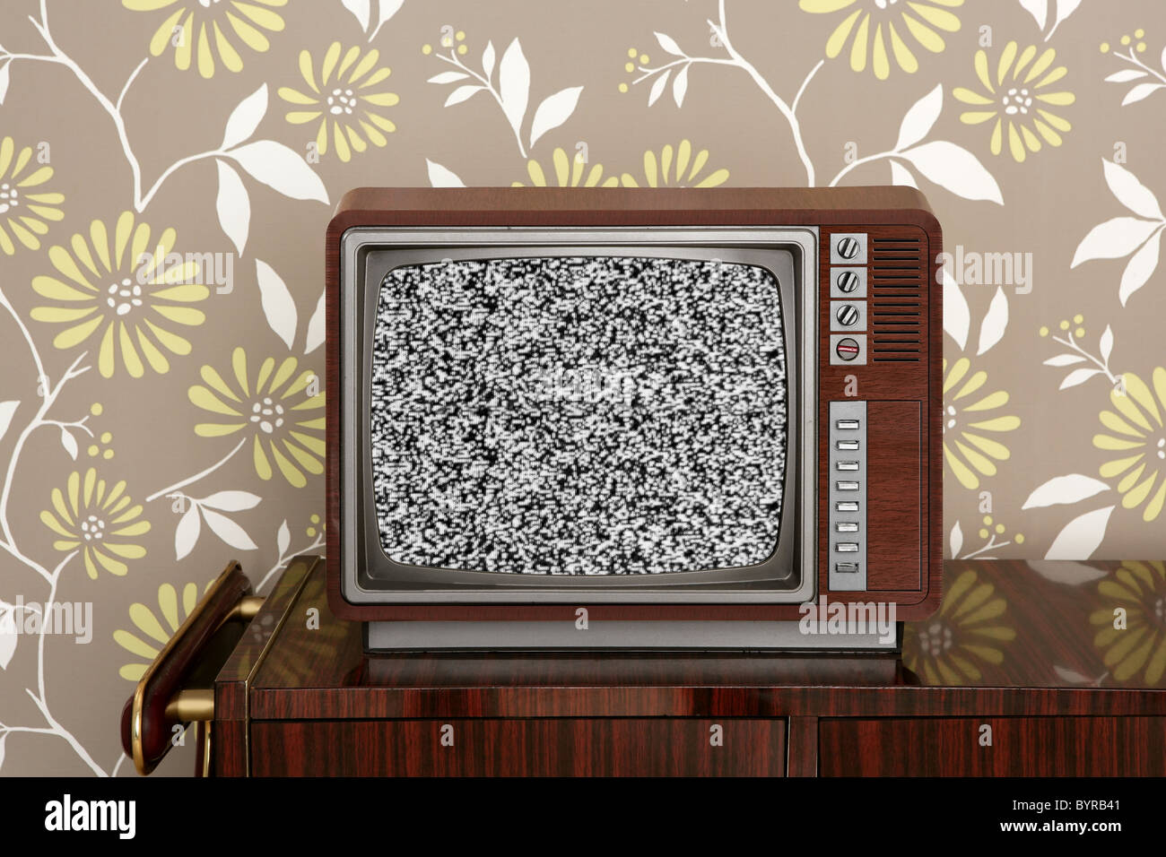 retro wooden tv on wooden vitage 60s furniture floral wallpaper Stock Photo