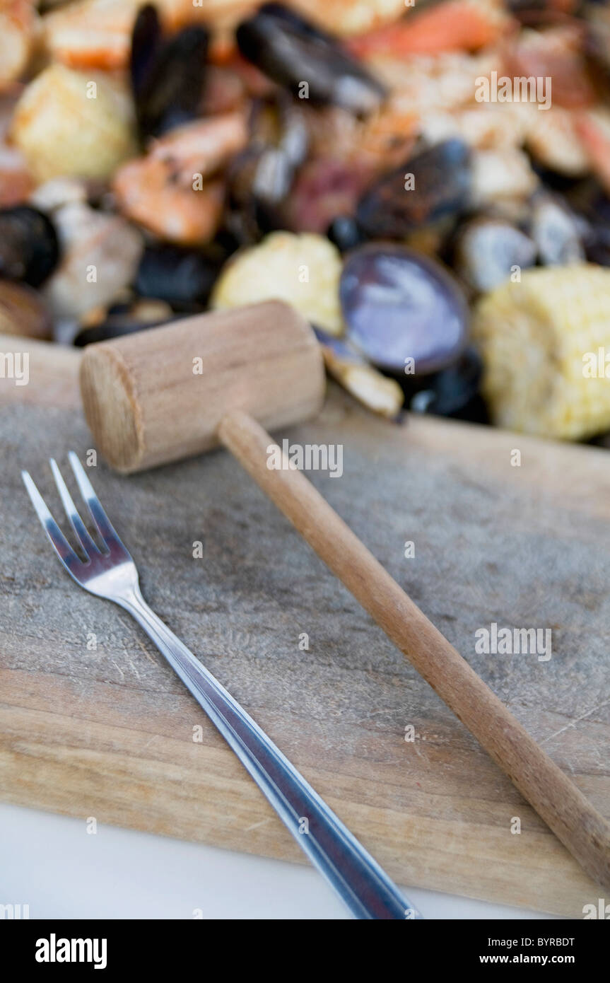 steamed seafood and a fork and mallet on a chopping block; seattle