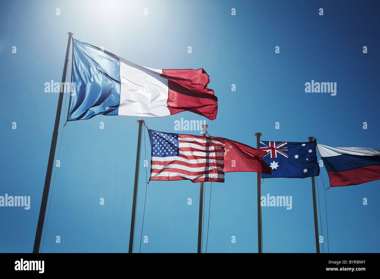 Image of different nations flags, cote de zur, nice, Monaco, displayed along side each other on flag poles. Stock Photo