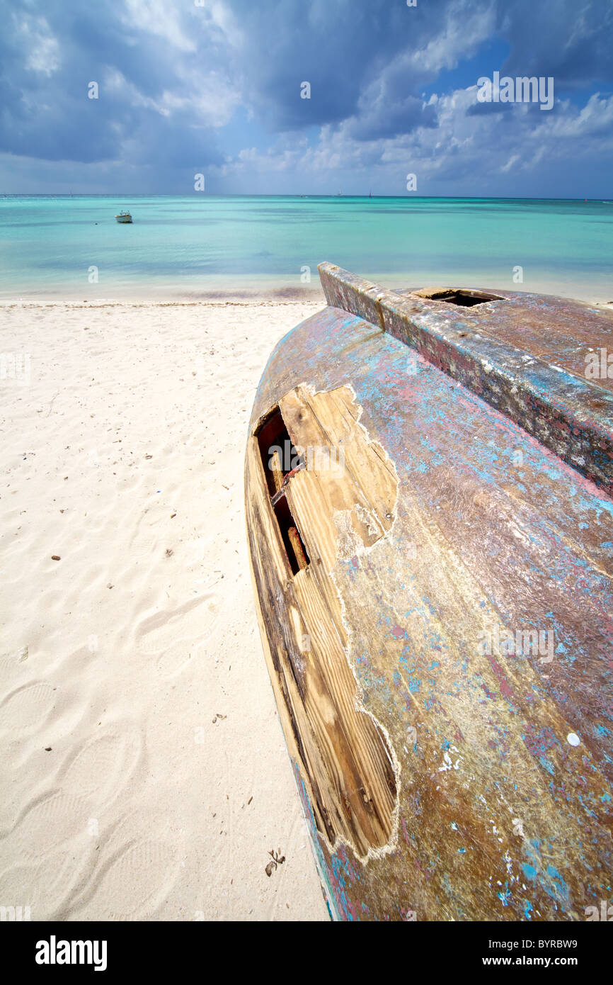 Shipwreck of a Wooden Boat on the Coastline of the Turquoise Water of the Caribbean Sea Stock Photo
