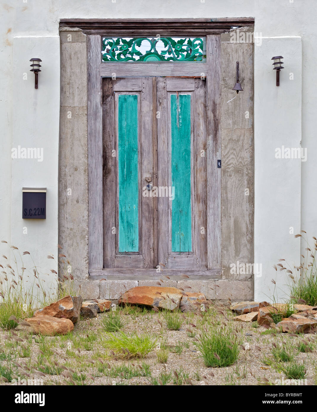 Weathered Wood Door with Green Panels in the Caribbean Island of Aruba Stock Photo