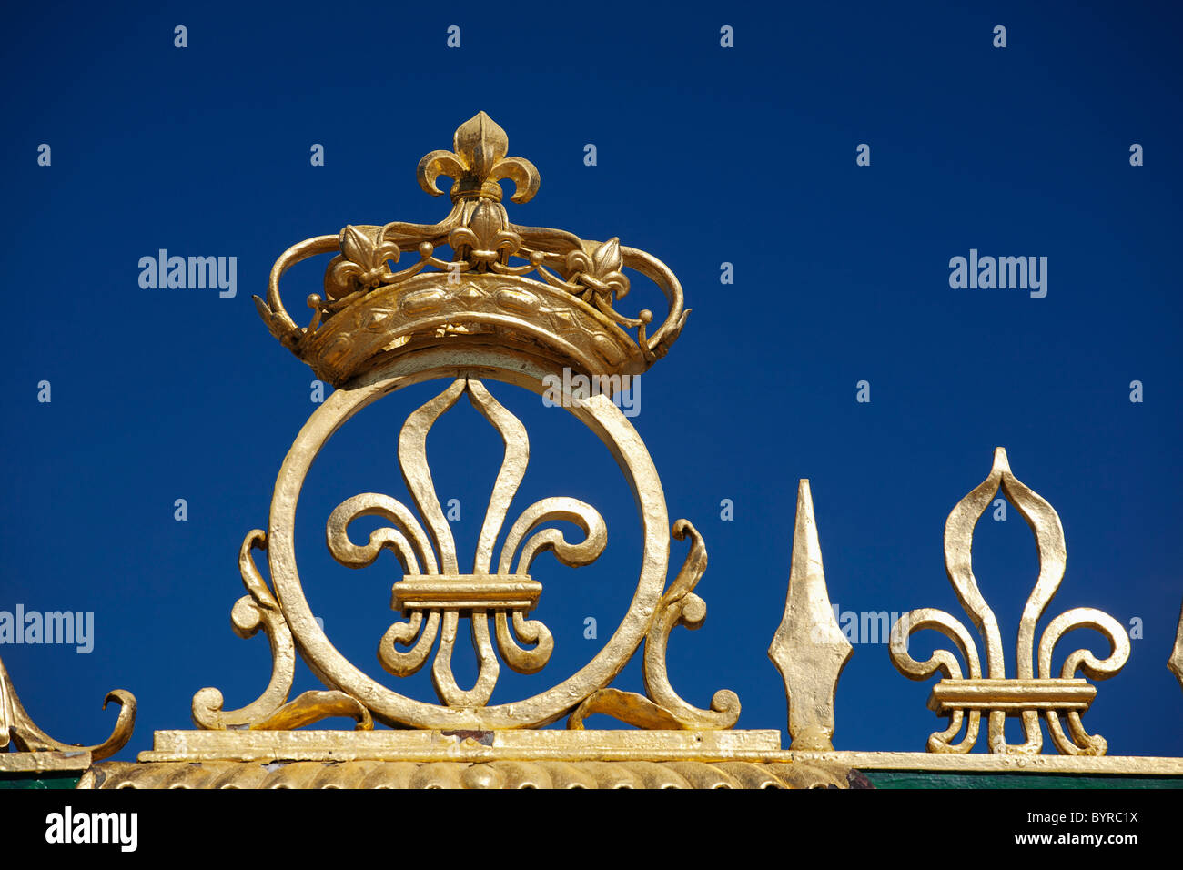 gold crown and fleur-de-lis on the grand trianon gates  in the gardens of the palace of versailles; paris, france Stock Photo