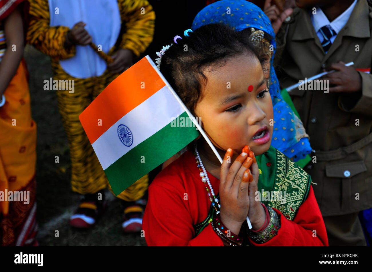A small indian girl singing patriotic song with indian national flag ...