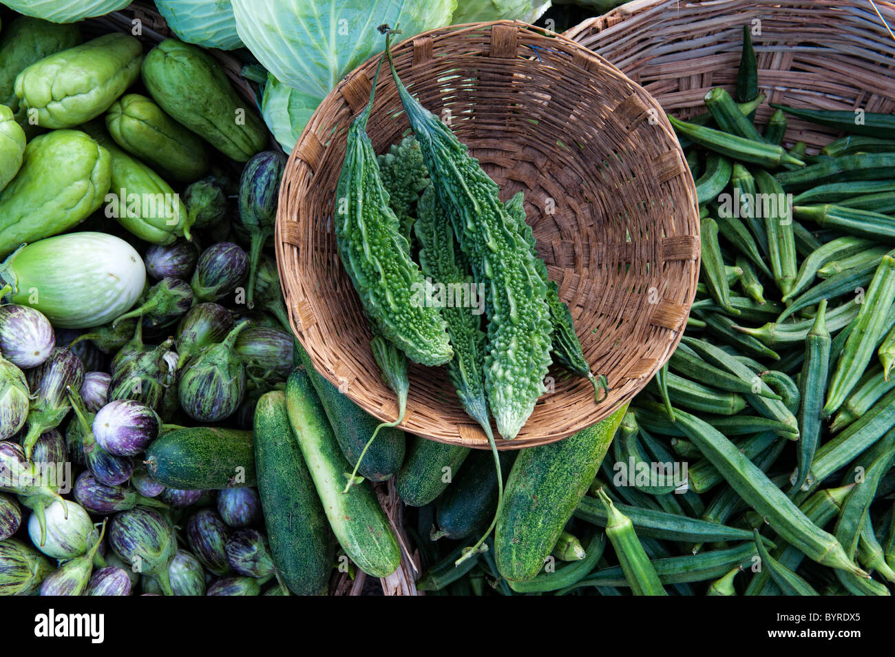 Bitter gourd, aubergine and okra in baskets at an Indian market. Andhra
