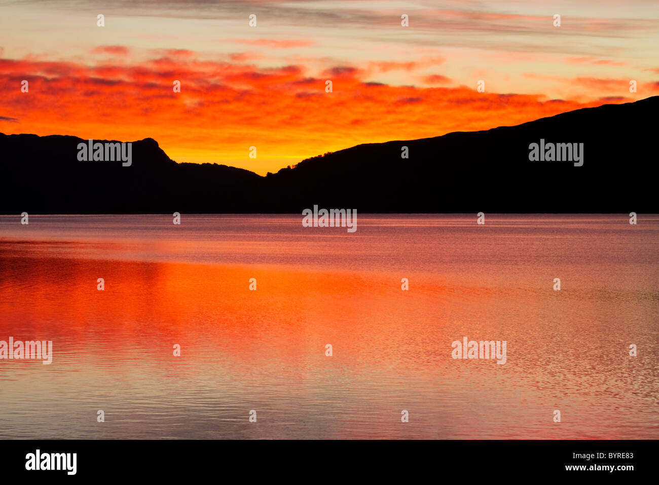Loch Katrine in the 'Loch Lomond and Trossachs National Park' at sunrise in autumn, Stirling, Scotland Stock Photo