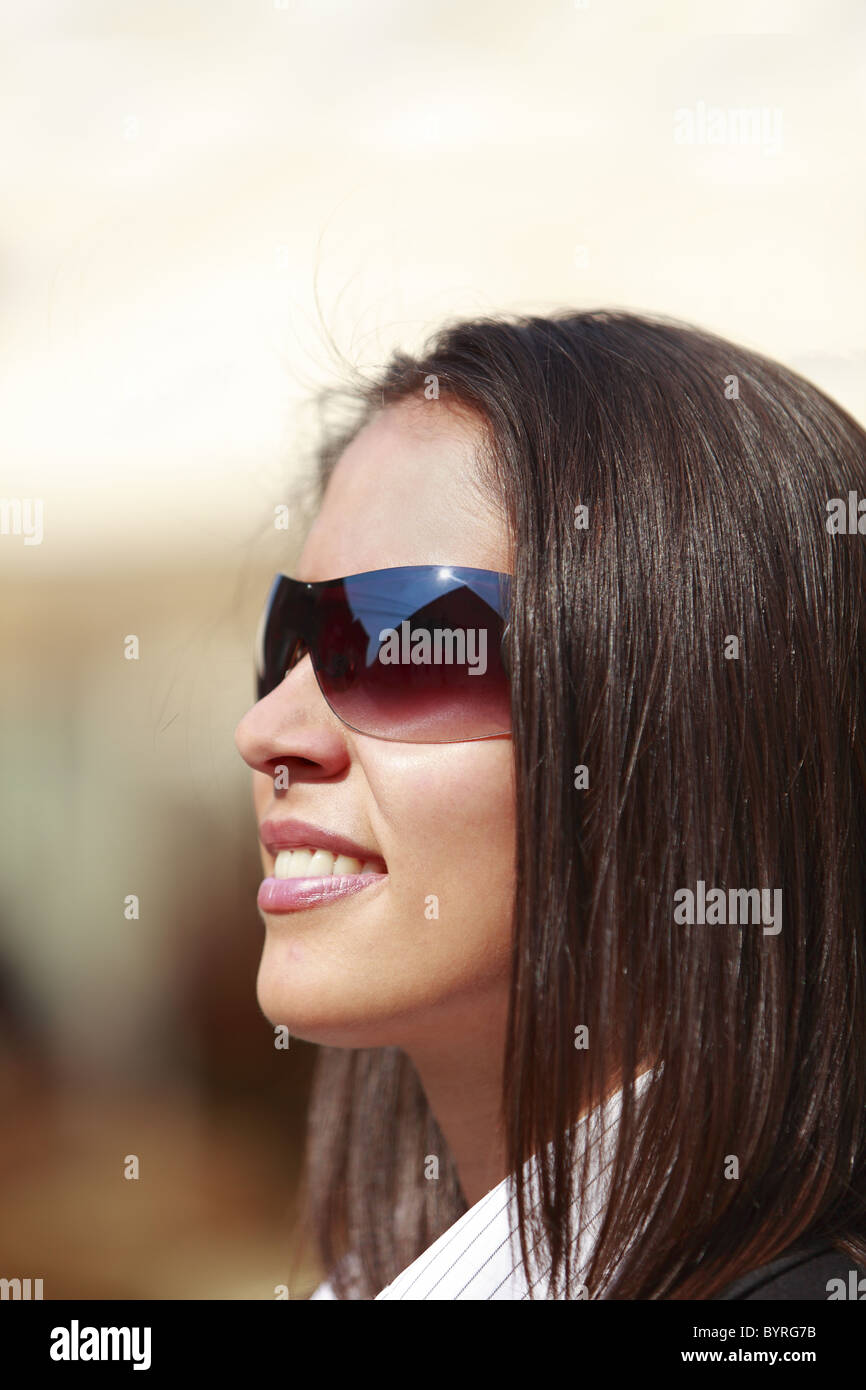 Portrait of a young woman wearing sunglasses Stock Photo - Alamy