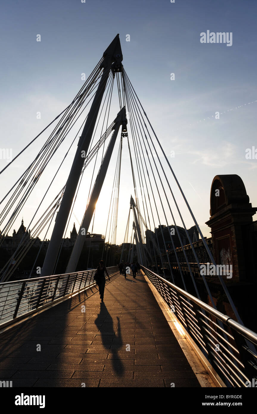 People on Golden Jubilee Bridge, London at sunset Stock Photo