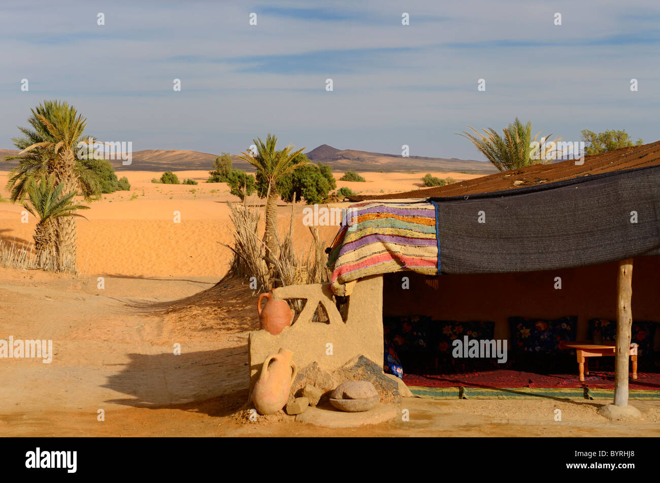Berber tent and palm trees at the edge of the desert in Khemlia Morocco Stock Photo