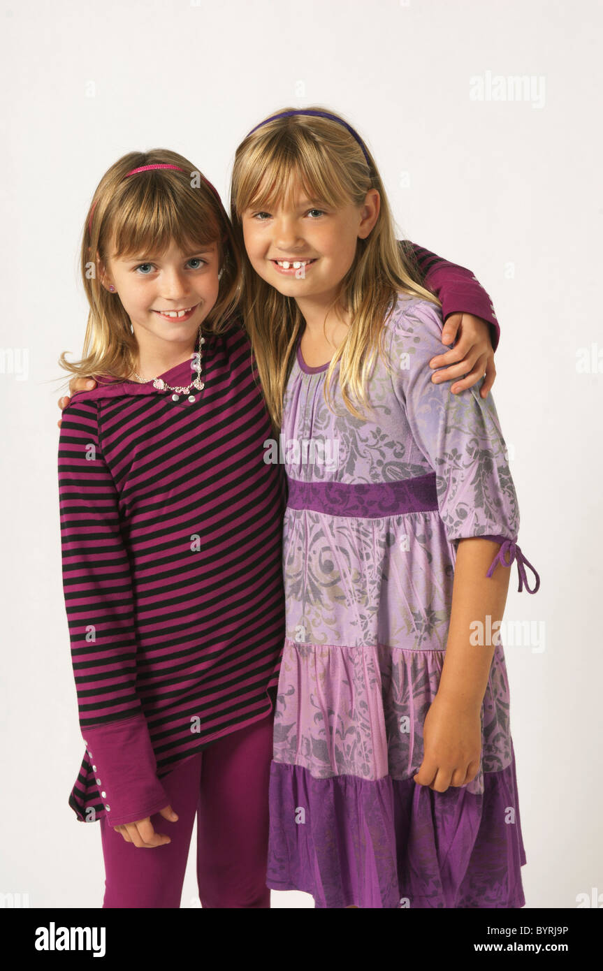 two girls wearing purple with their arms around each other Stock Photo ...