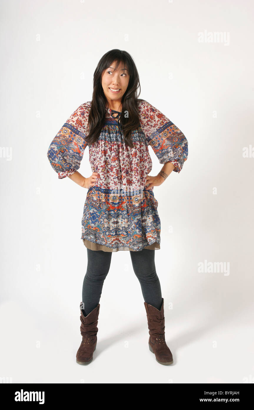 a woman standing with hands on her hips Stock Photo - Alamy