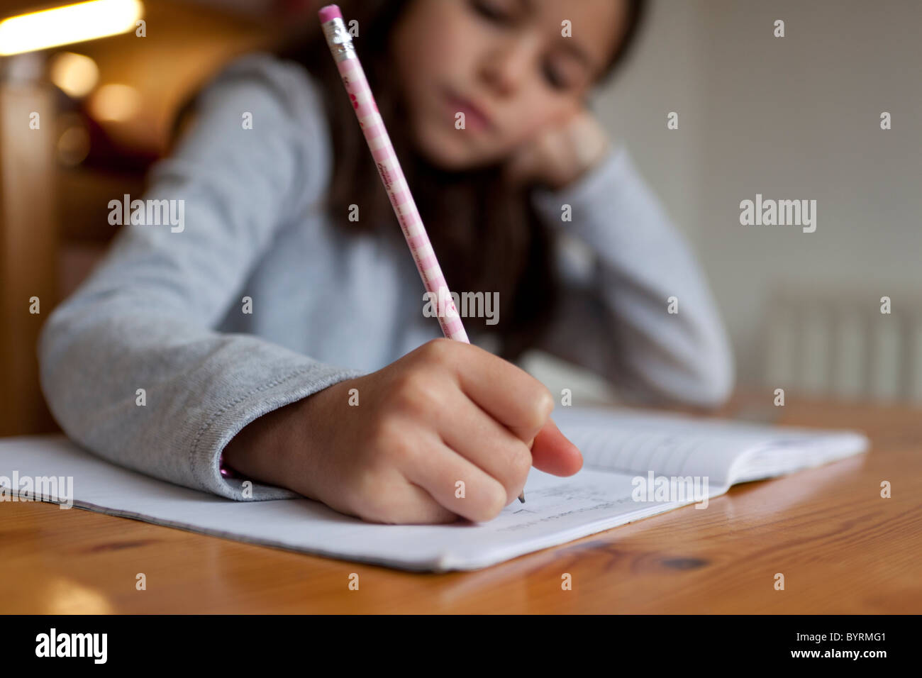 8 year old girl doing her homework Stock Photo