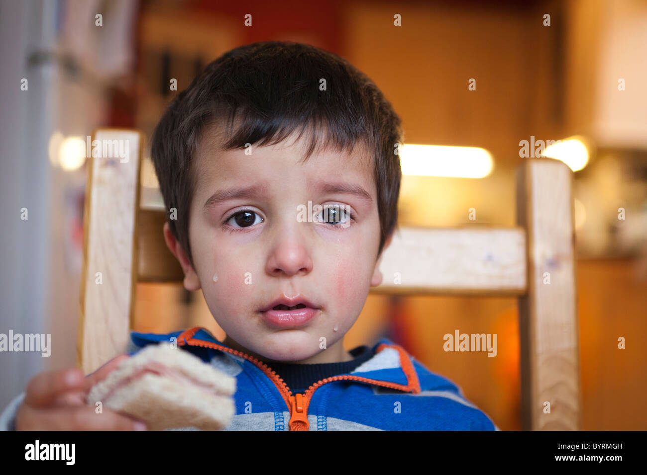 2 year old boy crying with tears running down his cheeks Stock Photo