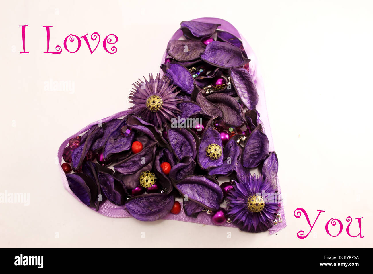 Greeting Valentine card with violet flowers and beads. Stock Photo