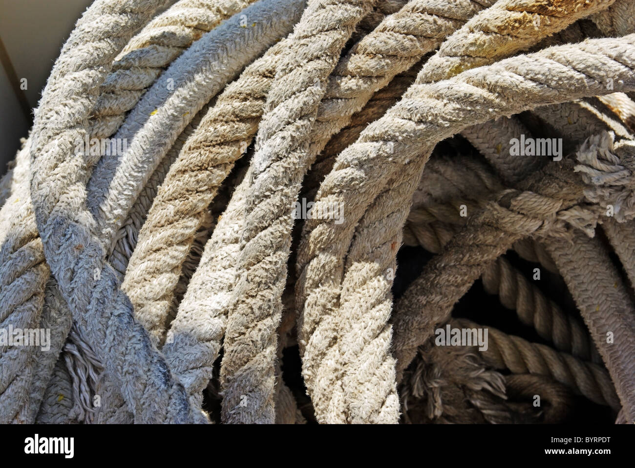 Rope with anchor on yacht for sailing as background. Stock Photo