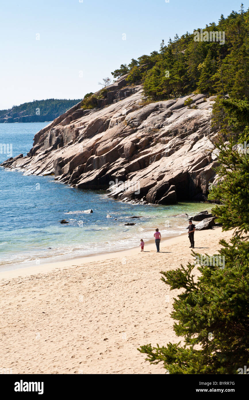 Visitors play at Sand Beach in Acadia National Park near Bar Harbor