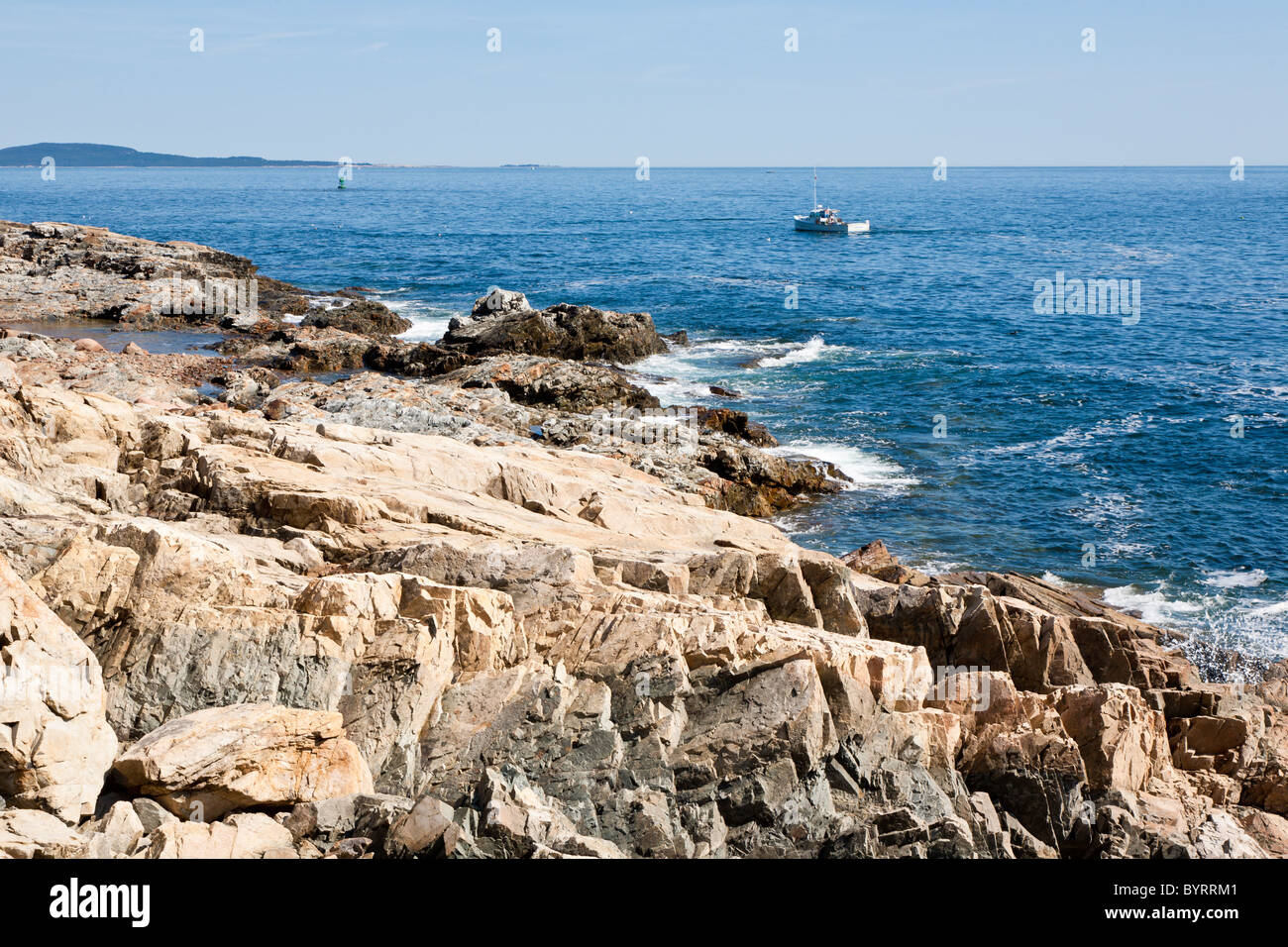 Fishing boat off rocky coastline in Acadia National Park near Bar