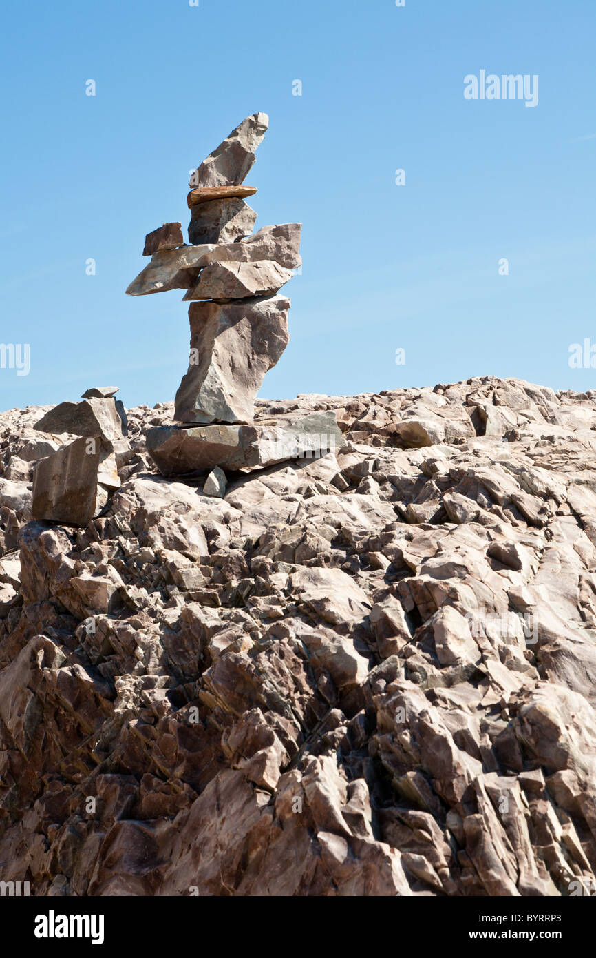 Stacked rocks form a cairn on the rocky coastline in Acadia National