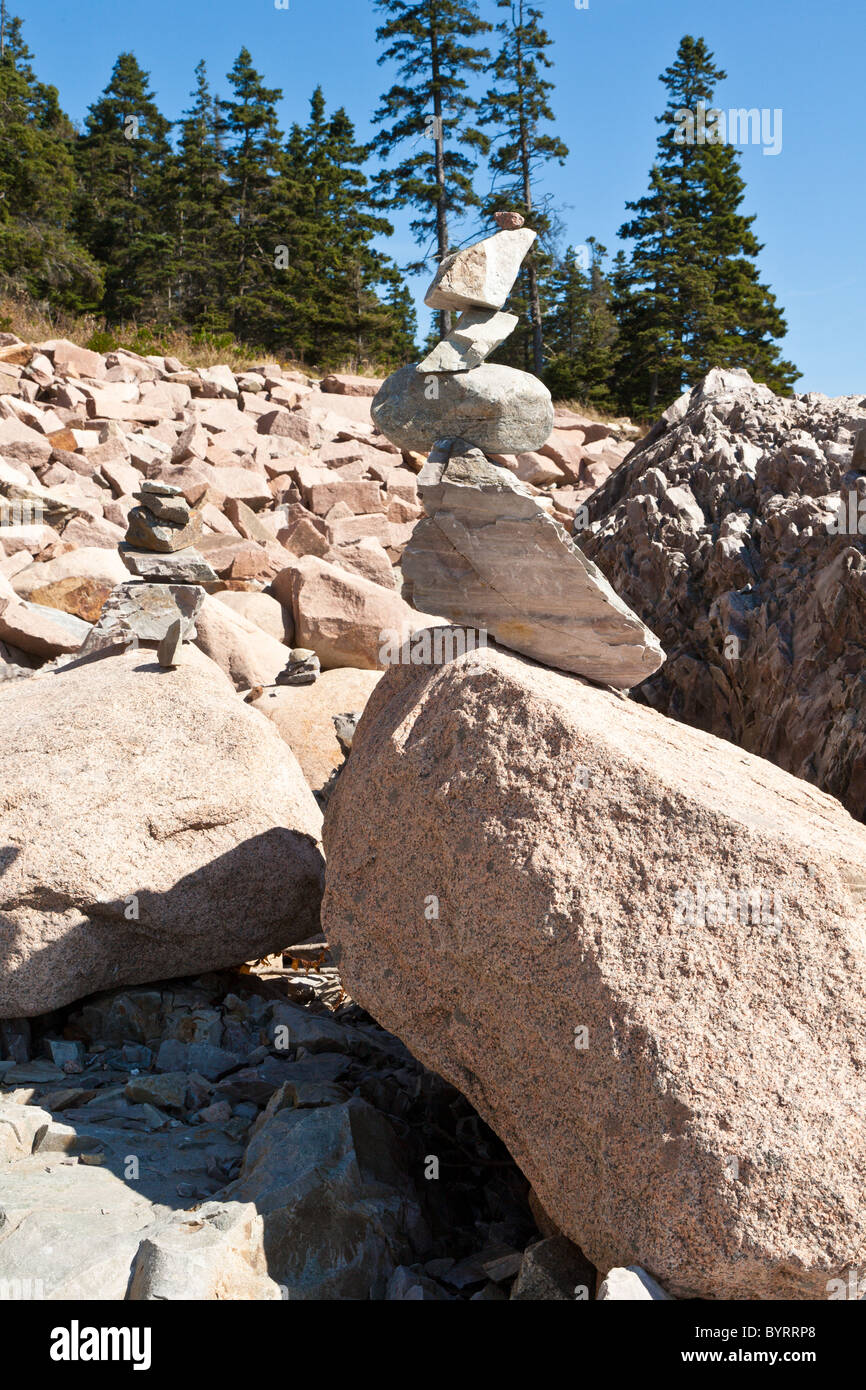 Stacked rocks form a cairn on the rocky coastline in Acadia National