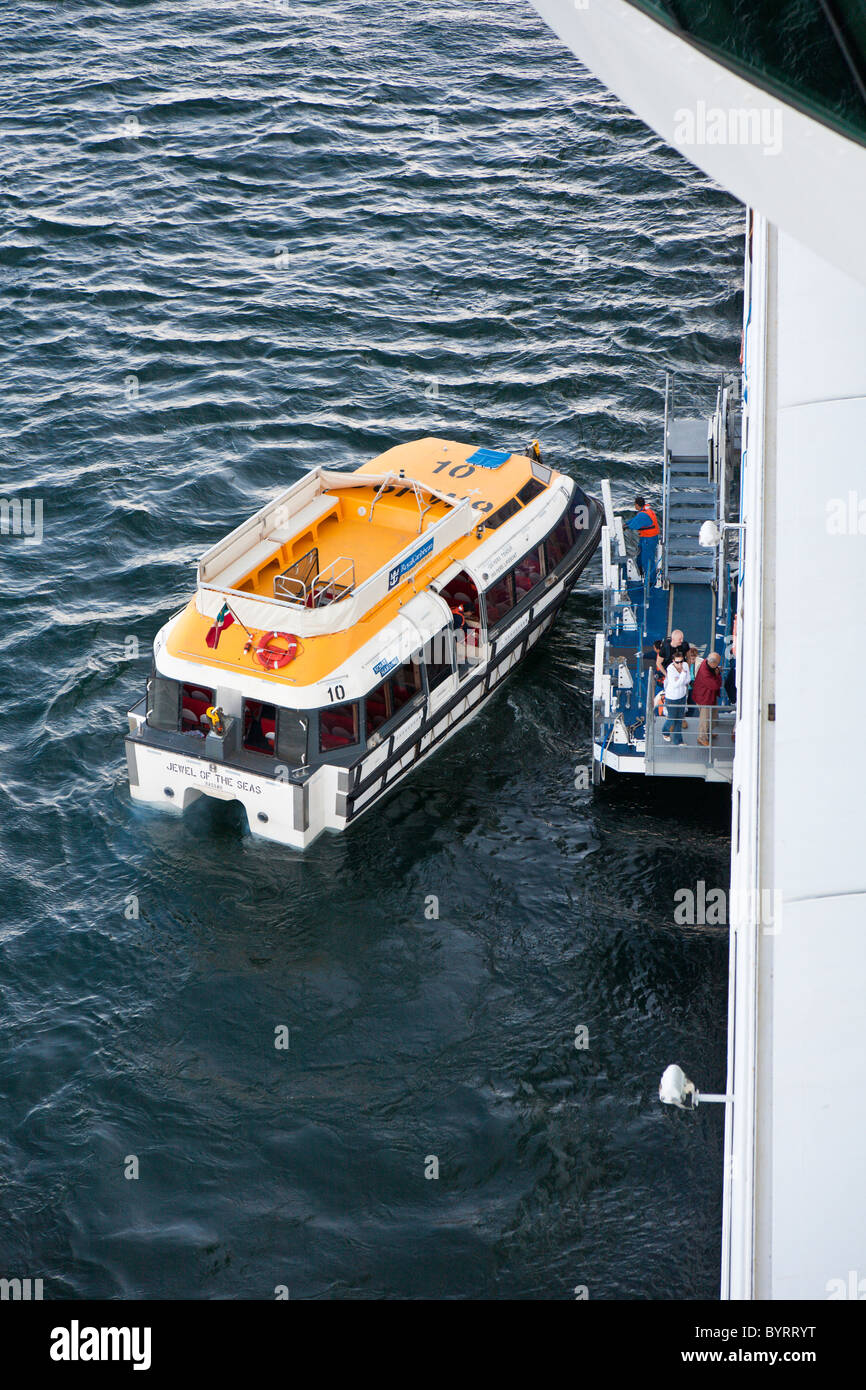 Tender boats carry cruise passengers between cruise ship and port. Stock Photo