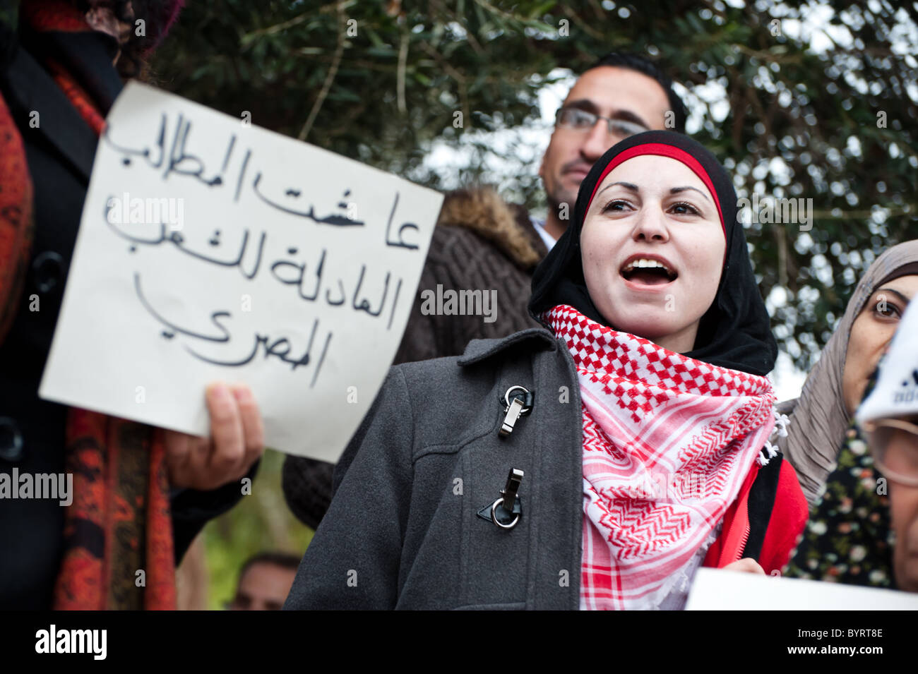 A group of Palestinian activists holds signs and chants slogans in solidarity with anti-government protests in Egypt. Stock Photo