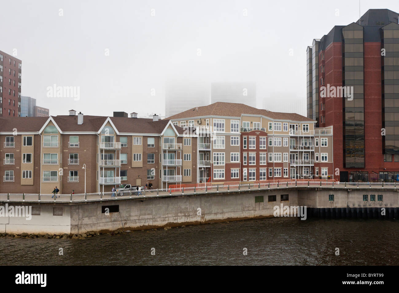 New waterfront residential housing units on a foggy day at the port in