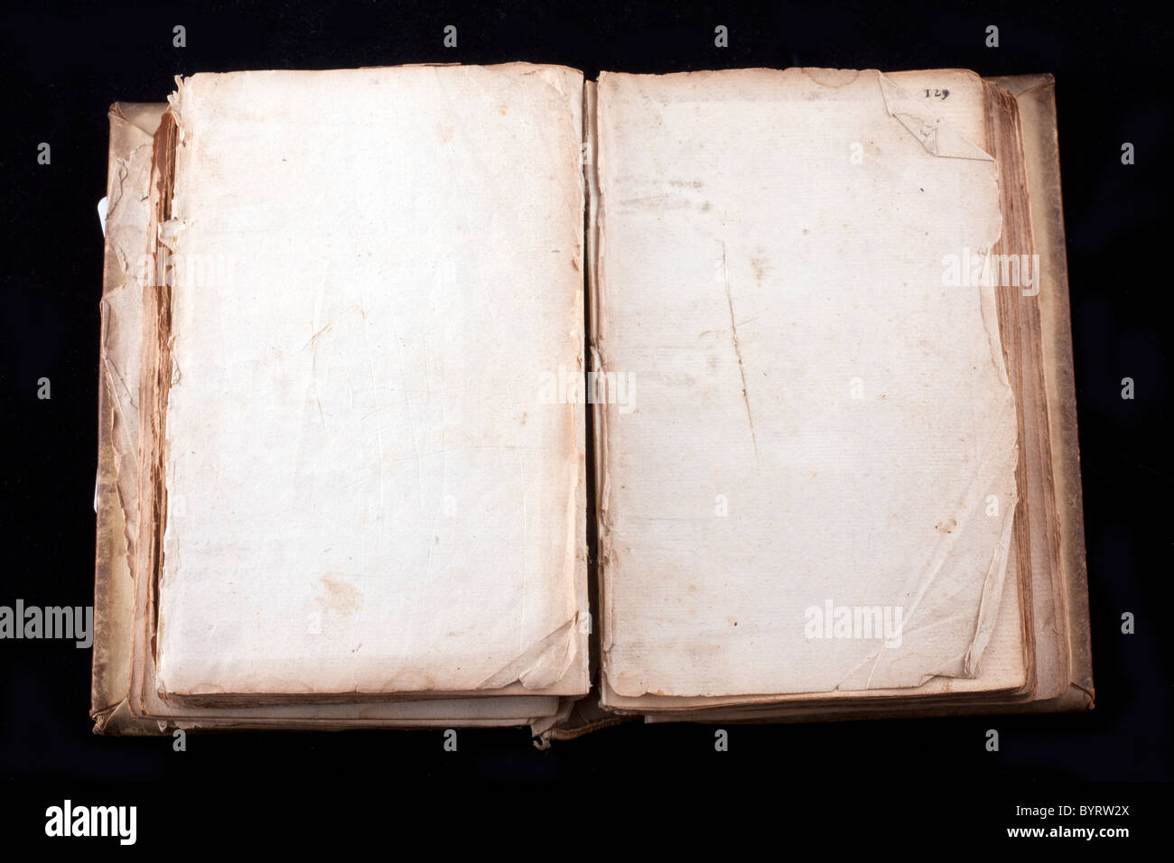 ancient book, almost 300 years, opened on two blank sheets isolated on black Stock Photo