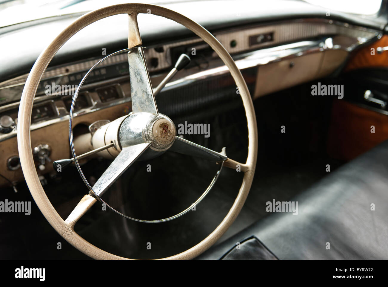 Interior of a vintage car with the steering wheel on the foreground. Holguin, Cuba, Caribbean. Stock Photo