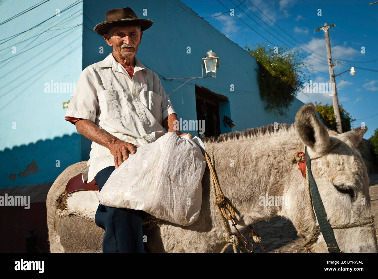 Old man with hat on his donkey , Trinidad, Sancti Spiritus, Cuba. Stock Photo