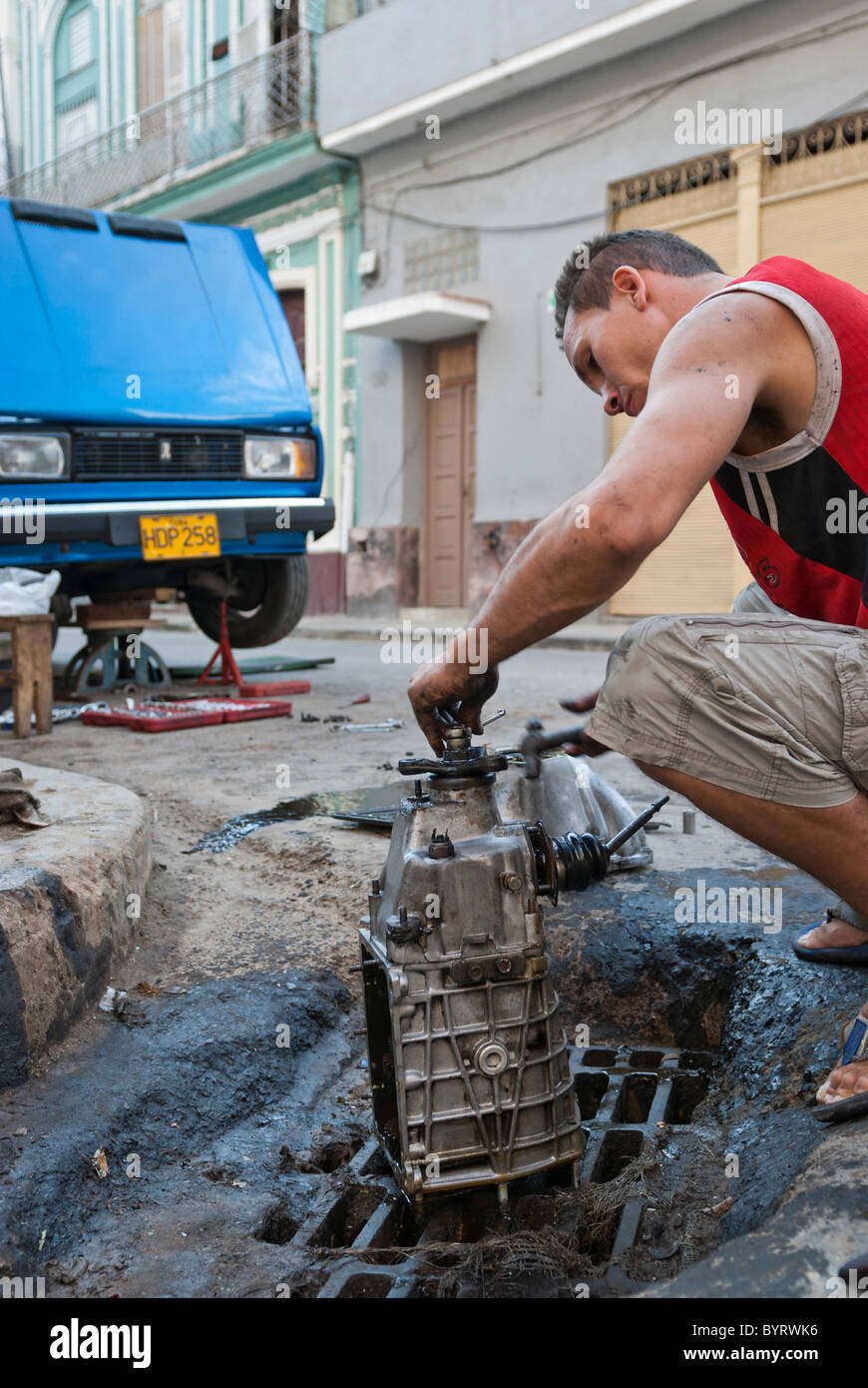 Man repairing his old car on the streets of La Habana, Cuba Stock Photo